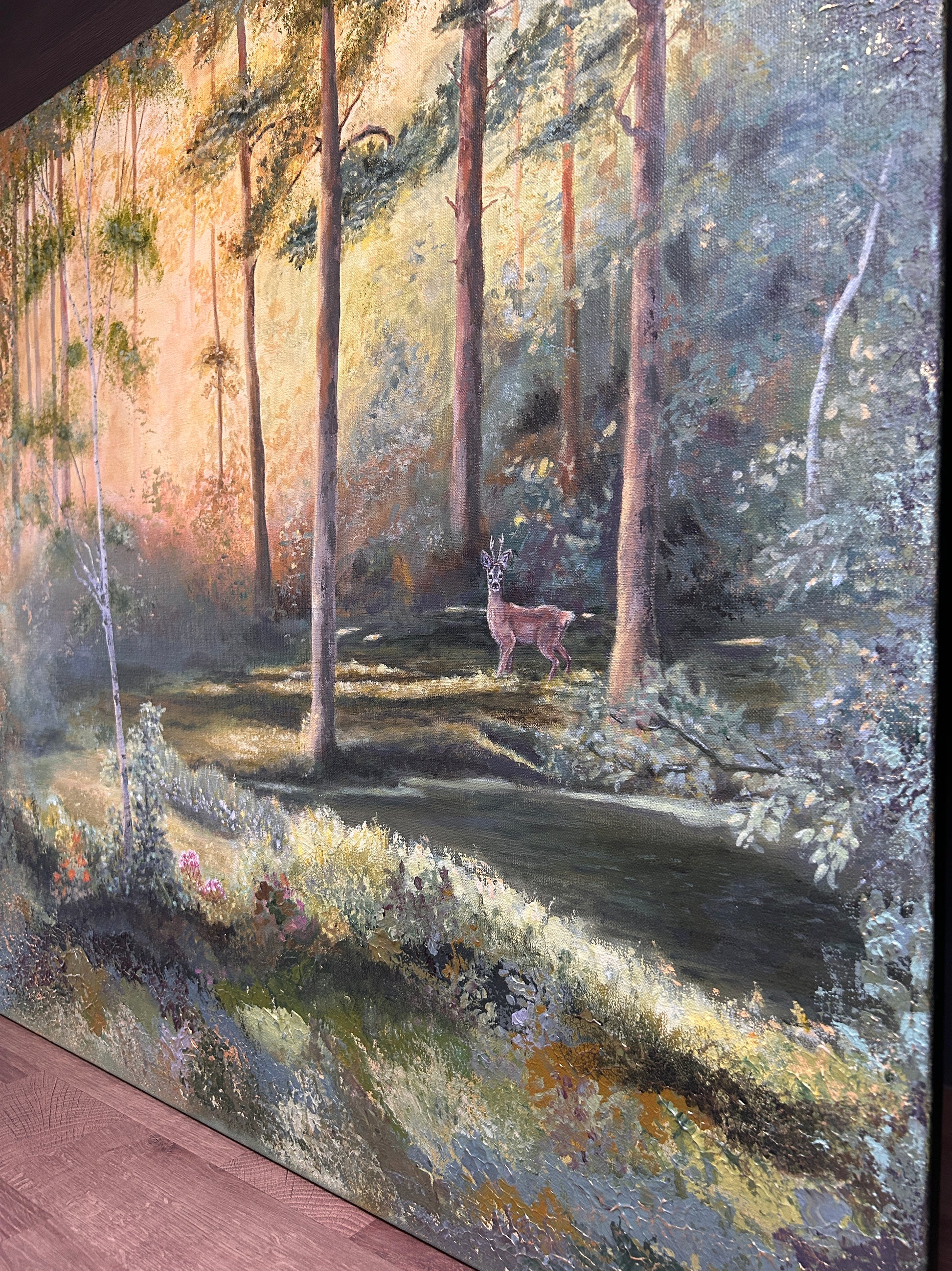 Artistic depiction of a forest scene with trees and a path.