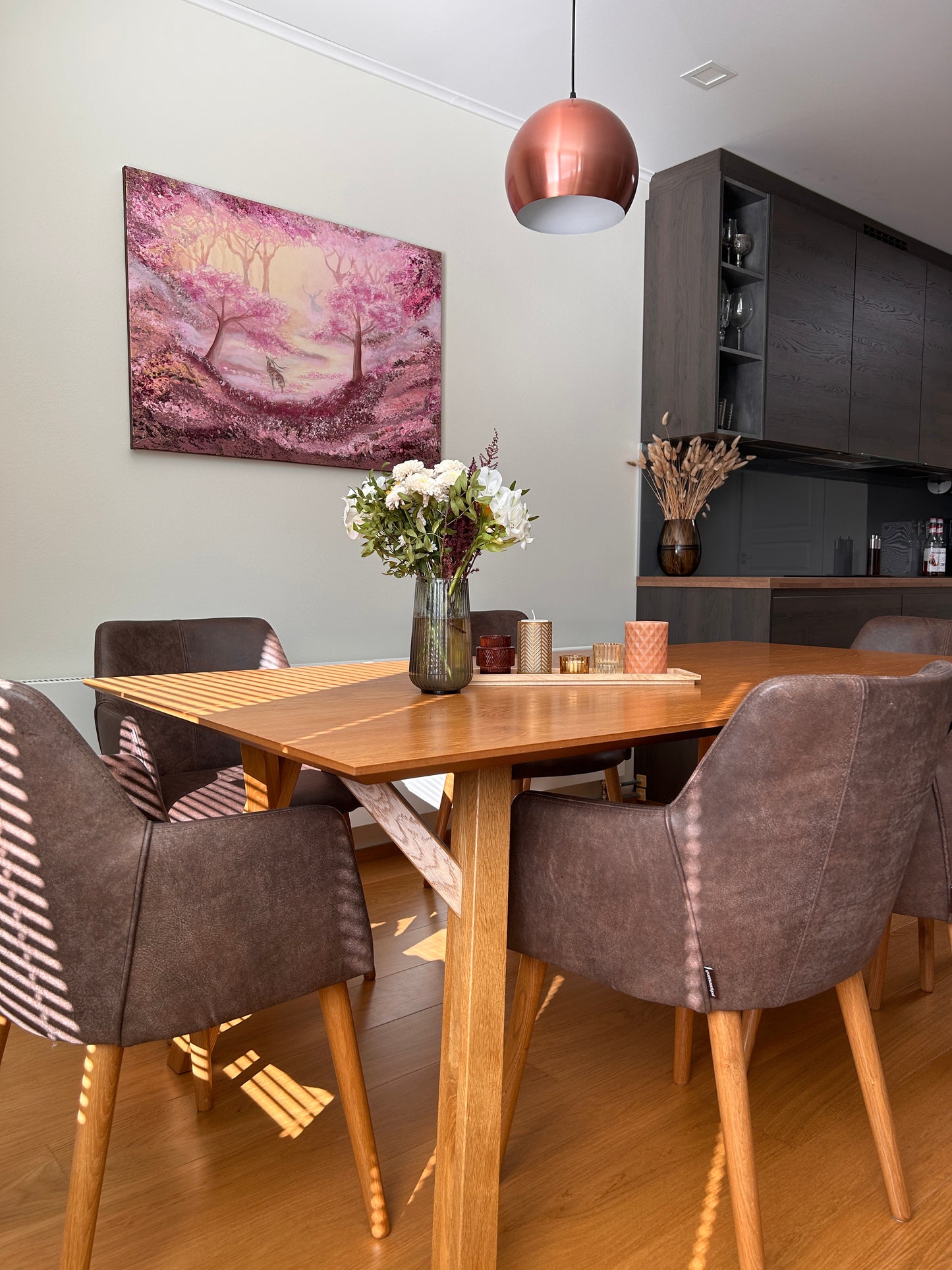 Top-down view of a modern kitchen with a dining area featuring a table and chairs.